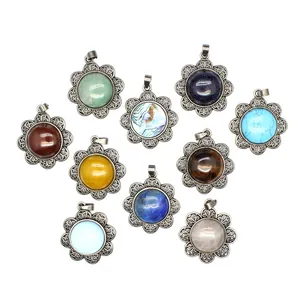 Detail view of ten flower-shaped antique silver pendants with varied colorful stones.