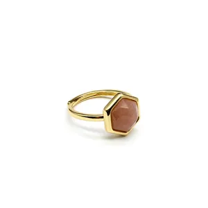 Detail of hexagonal sunstone set in gold adjustable ring with polished finish