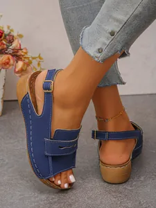 Close-up of blue peep-toe wedge sandals with wooden platform and buckle strap