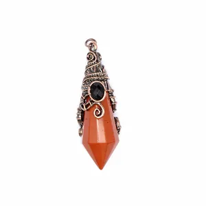Macro view of a faceted red jasper wizard hat pendant with antique copper wire wrap.