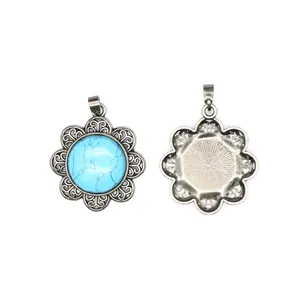 High detail macro view of vintage silver flower pendant with blue turquoise stone inlay.