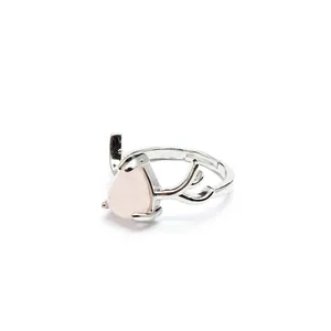 Detailed view of the pink teardrop stone and silver antler design on this adjustable ring