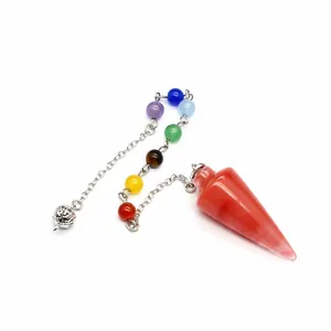Close-up of conical red stone pendulum with seven colorful chakra beads on chain