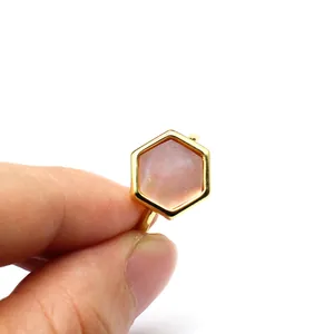Detailed macro view of a hexagonal natural sunstone ring with elegant golden setting