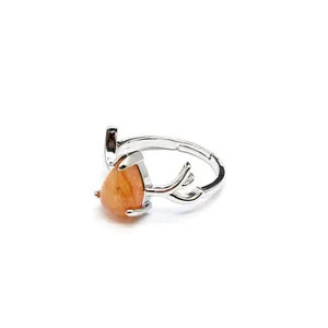 Macro view of silver reindeer antler ring with a teardrop-shaped orange natural stone