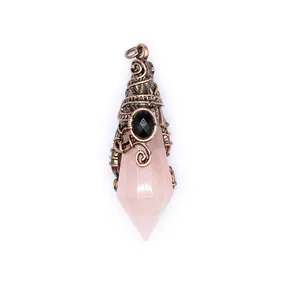 Close-up detail of a pink faceted crystal wizard hat pendant with intricate bronze wire wrap