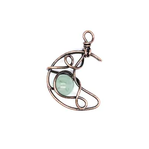 Detail of handcrafted moon pendant with green natural stone and copper wire wrap