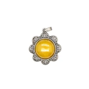 Close-up detail of a vintage antique silver flower pendant with a yellow gemstone