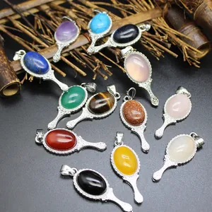 Detail of magic mirror pendants featuring various colorful natural stone cabochons