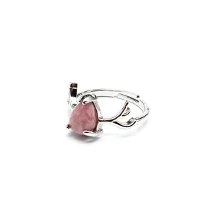 Close-up of a pink teardrop natural stone set on a silver-toned deer antler open ring