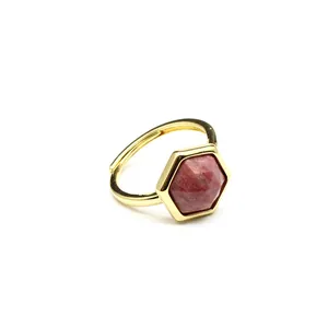 Detailed view of a hexagonal red sunstone crystal set in a minimalist gold adjustable ring