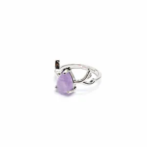 Detailed close-up showing the purple teardrop stone and silver antler design of the ring