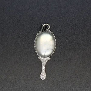 Detailed view of an ornate silver magic mirror pendant with a white natural stone.