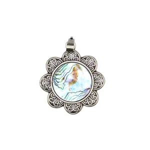 Detailed view of an antique silver flower pendant featuring a natural abalone shell inlay