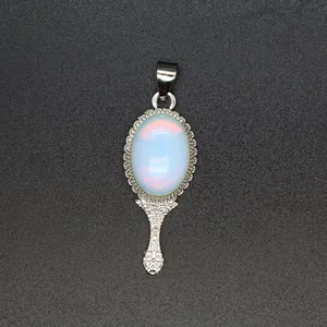 Close-up shot of a vintage hand mirror pendant with ornate silver filigree and opal stone