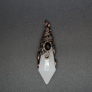 Macro detail of natural stone crystal pendant with wire wrapped wizard hat design