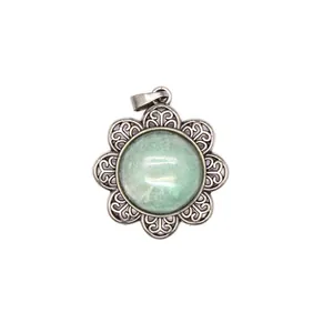 Detailed view of a vintage flower-shaped pendant with a green natural stone center