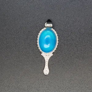 Close-up of a vintage blue stone magic mirror pendant with silver filigree frame