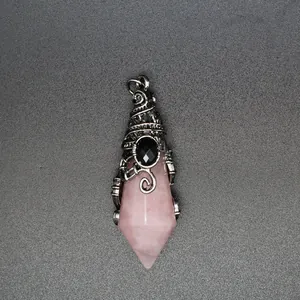 Detailed macro view of natural rose quartz pendant with mystical wizard hat metal wrap.