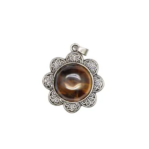 Detailed view of an antique silver flower pendant featuring a brown tiger's eye stone