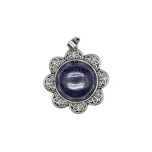 Macro view of vintage flower pendant with starry blue sandstone in antique silver setting.