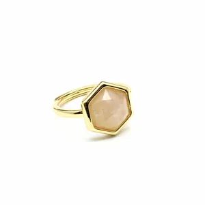 Detailed macro view of a hexagonal cut sunstone ring with a gold adjustable band