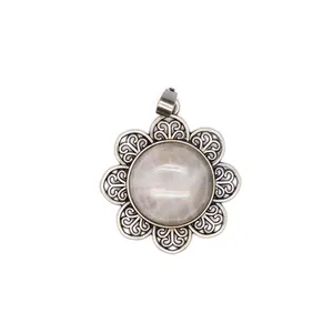 Close-up detail of a vintage antique silver flower pendant with a natural stone center