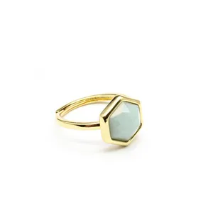 Close-up of hexagonal natural stone crystal ring with adjustable gold-plated band.
