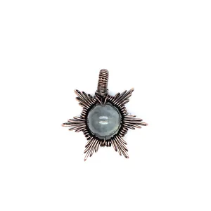Detailed macro view of handmade copper wire-wrapped natural sun stone star pendant