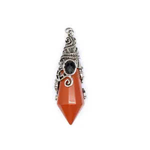 Detail of a witch hat shaped natural red stone pendant with vintage wire wrap.