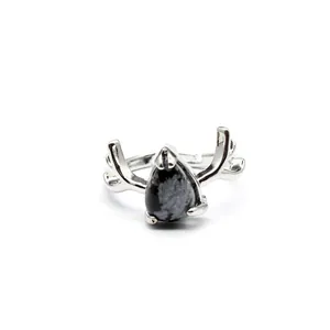 Detailed view of a silver antler ring with a teardrop-shaped snowflake obsidian stone