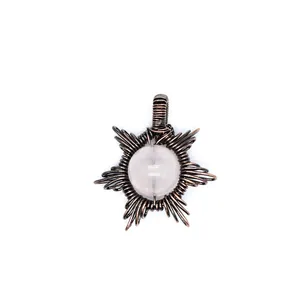 Detailed macro view of a unique handmade wire-wrapped natural stone sun shaped pendant.