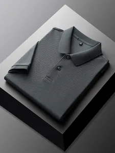Detail of folded dark grey piqué cotton polo shirt for men on geometric display.