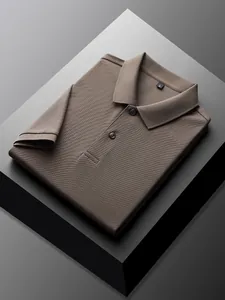Close-up of folded men's brown cotton pique polo shirt with collar and button detail.