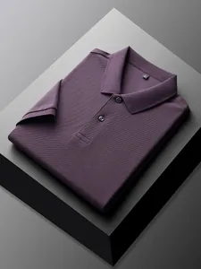 Premium men's purple 100% cotton polo shirt folded on minimalist geometric display block