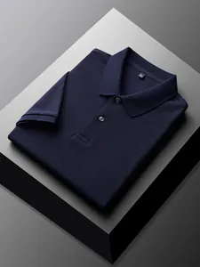 Macro view of a folded navy blue cotton polo shirt with pique texture on a geometric pedestal