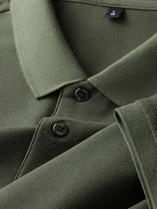 Macro detail of olive green men's polo shirt showing pique knit texture and buttons