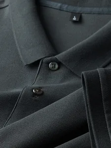 Close-up detail of charcoal grey men's 100% cotton pique Polo shirt texture