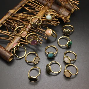 Collection of adjustable gold rings featuring faceted hexagonal natural stone crystals