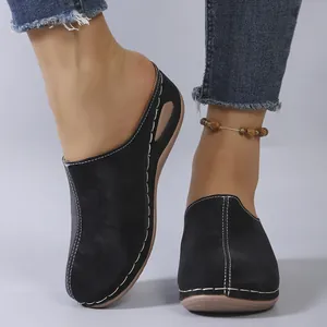 Stylish black closed-toe wedge mules featuring elegant contrast white stitching for women