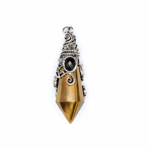 Macro view of a faceted tiger eye crystal pendant with intricate silver-tone metal wizard hat wrap