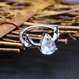 Close-up of teardrop crystal and silver antler design on an adjustable ring.