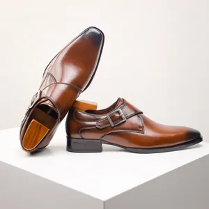 Detailed view of brown leather monk strap shoes with burnished toe and buckle