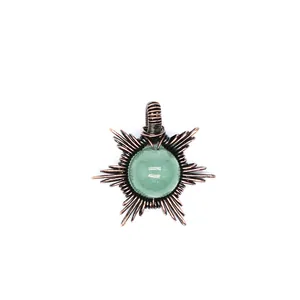 Detail view of handmade sun pendant with green natural stone and wire wrapped rays