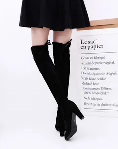Full view of black suede over-the-knee boots with chunky high heels and lace-up back detail.