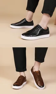 Close-up detail of men's casual leather sneakers in black and brown finishes.