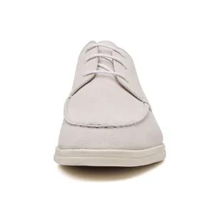 Front view detail of beige suede lace-up loafers with a comfortable white rubber sole