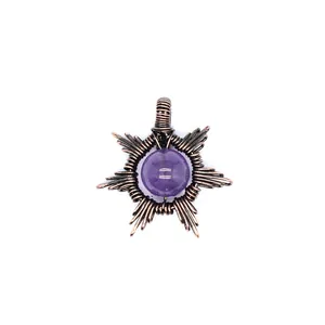 Detailed macro view of handmade wire-wrapped sun pendant with purple amethyst stone bead