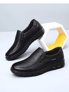 Detail view of black textured leather loafers for men with durable rubber soles.