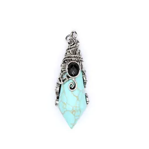 Close-up of wizard hat shaped faceted turquoise pendant with vintage silver wrap